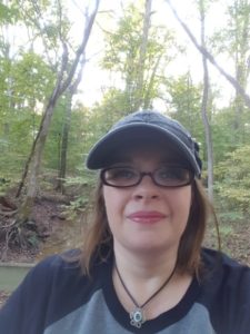 It's me, in the woods, wearing a cap and the mildly creepy eye  necklace I break out every year at Halloween.